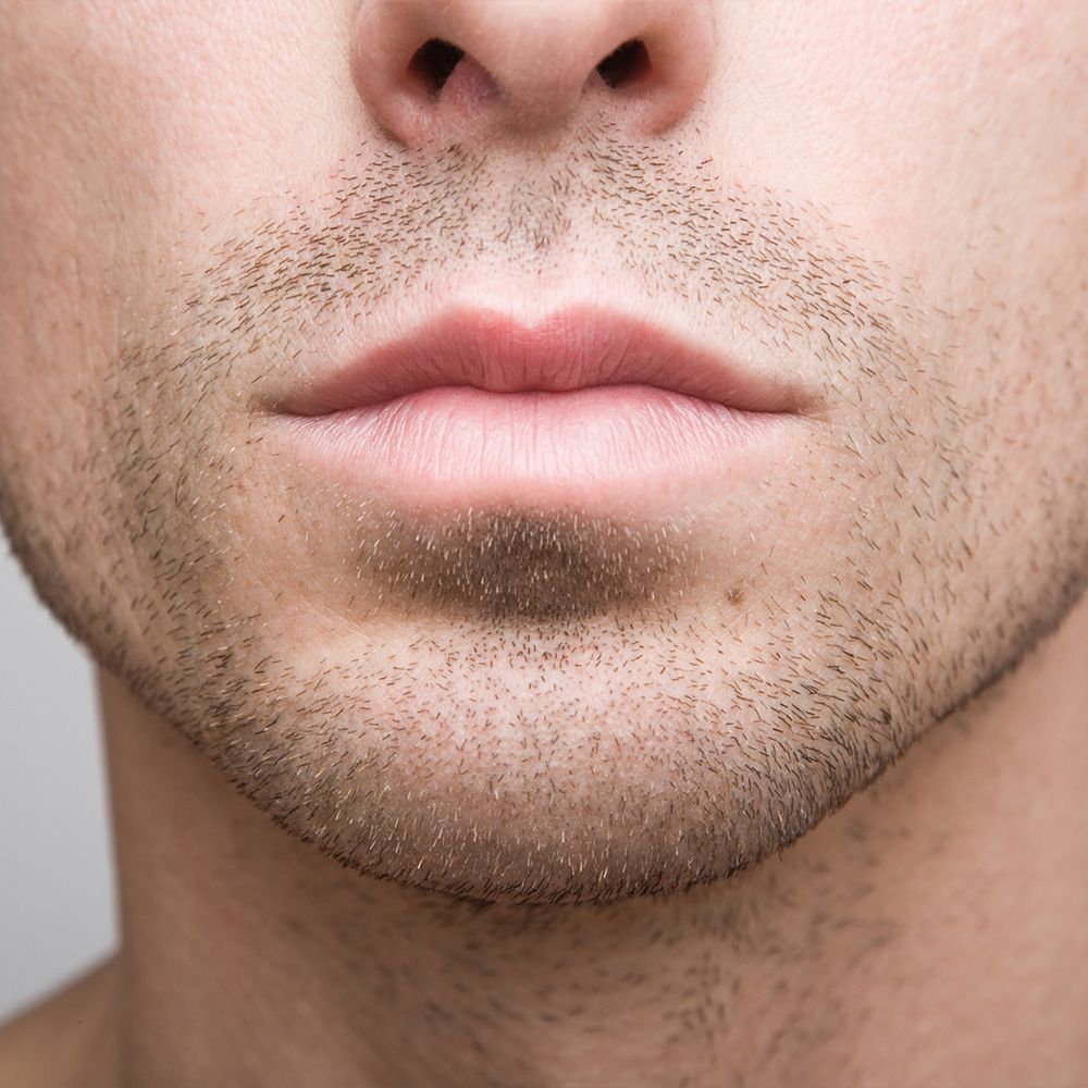 Profile view of a woman's face, displaying a chiseled chin and jaw line